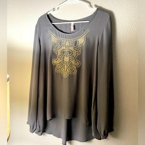 Flowy grey women’s blouse sz XL with a cream/gold colored emblem on the front